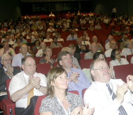 Doctors applaud one of the speakers at the BMA conference yesterday, where NHS privatisation was loudly condemned