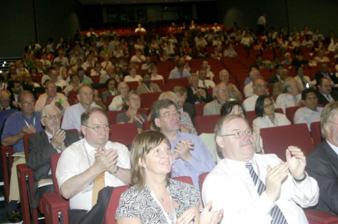 Doctors applaud one of the speakers at the BMA conference yesterday, where NHS privatisation was loudly condemned