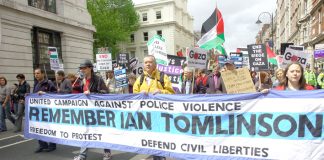 Banner commemorating Ian Tomlinson who died after being assaulted by police in the City of London on April 1st as he was trying to get home