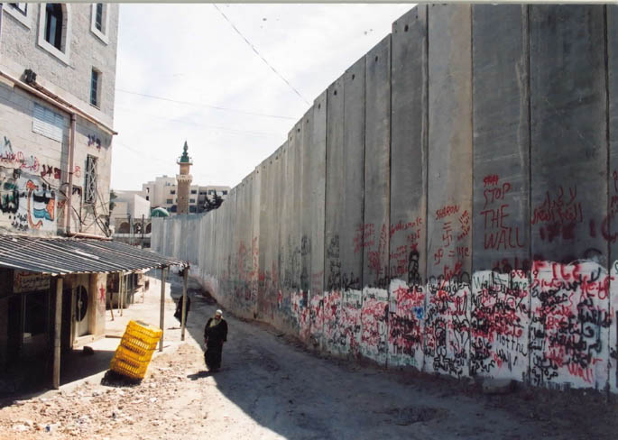 The land-grabbing Israeli separation wall looms over Abu Dis on the outskirts of Jerusalem