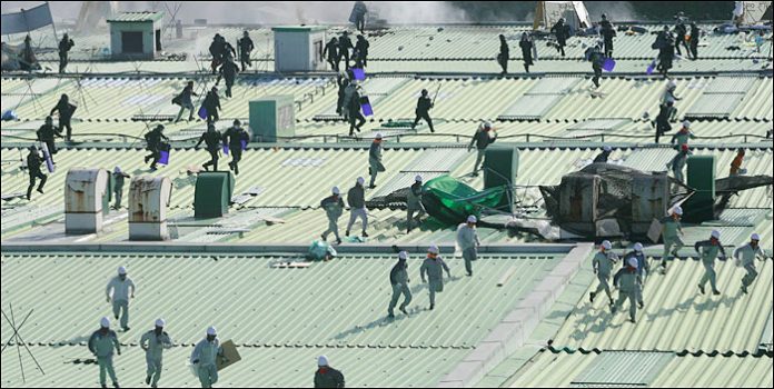 Korean SWAT police team members landed onto the roof of the Ssangyong assembly line building chase workers occupying the building in defence of their jobs