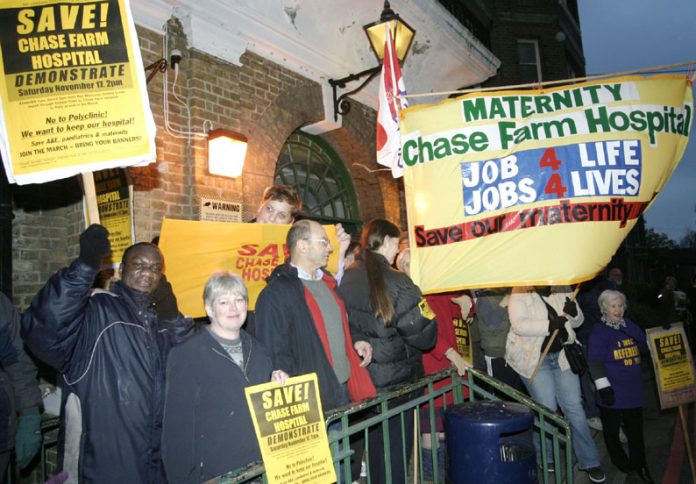 The North East London Council of Action demonstrating outside the clocktower entrance to Chase Farm Hospital. Now NHS hospitals face private takeover