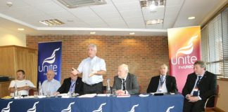 Chairman DAVE OSBORNE addresses the fringe meeting with Unite joint leaders TONY WOODLEY and DEREK SIMPSON on the right of the platform