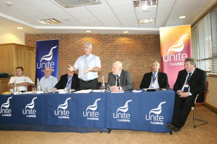 Chairman DAVE OSBORNE addresses the fringe meeting with Unite joint leaders TONY WOODLEY and DEREK SIMPSON on the right of the platform