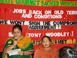 Sacked Gate Gourmet workers PARMJIT BAINS speaking and LAKHINDER SARAN (seated)