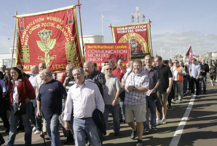 Postal workers march outside the Labour Party Conference urging the government not to back the break up of the industry