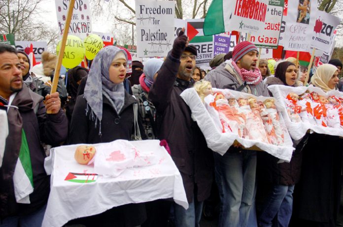 Marchers in London on January 10 last year depicting the slaughter of Palestinian children by the Israeli army last January