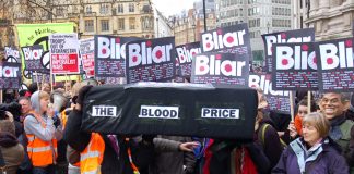 Demonstrators with a coffin illustrating the blood price of the Iraq war