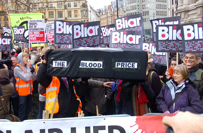 Demonstrators with a coffin illustrating the blood price of the Iraq war