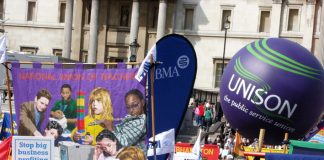 National Union of Teachers banner and Unison balloon at the Trafalgar Square rally to ‘Defend the Welfare State’ on April 10