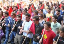 Greek youth march towards the police lines showing their determination to resist the savage cuts