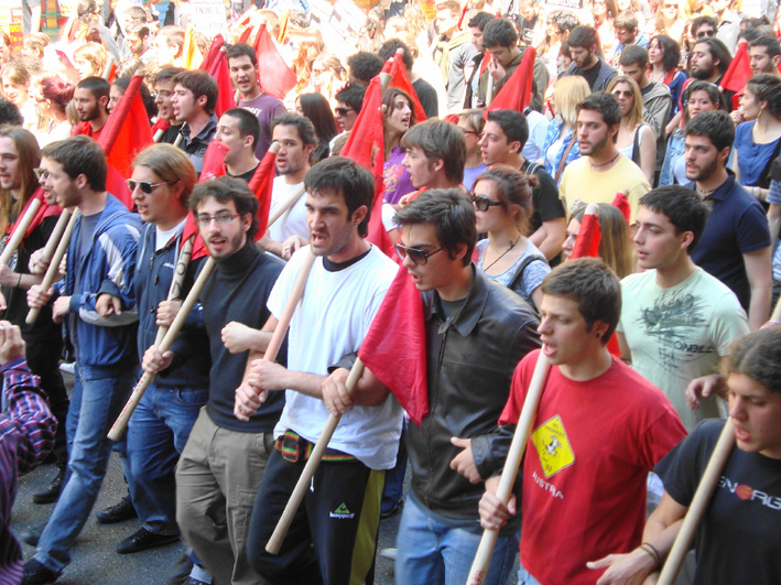 Greek youth march towards the police lines showing their determination to resist the savage cuts