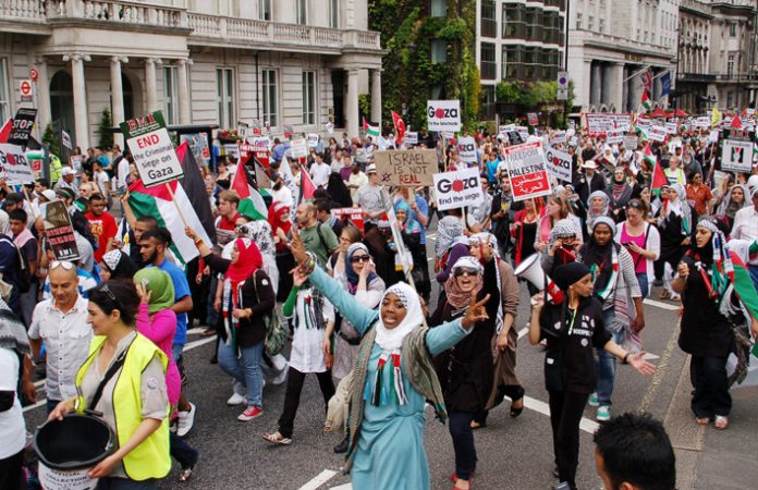 A section of Saturday’s 25,000-strong ‘Gaza Flotilla March’ makes its way towards the Israeli Embassy in Kensington