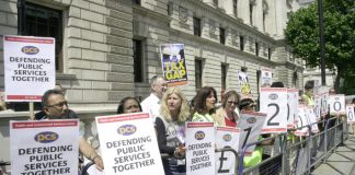 PCS members outside the Treasury yesterday highlight the £120 billion in outstanding tax debts owed by big business