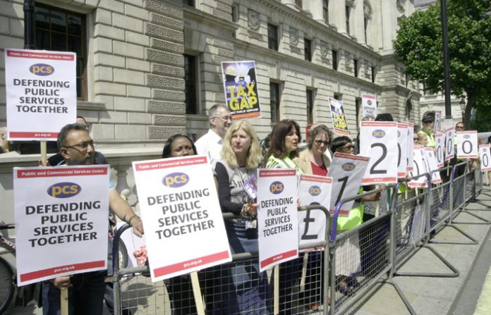 PCS members outside the Treasury yesterday highlight the £120 billion in outstanding tax debts owed by big business