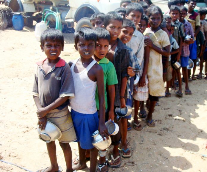 Hungry Tamil children queue for meagre rations