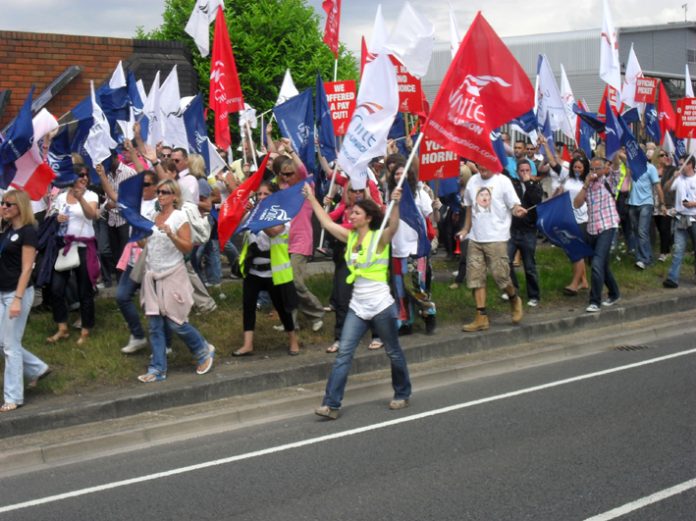 Striking BA cabin crew marching at Heathrow on June 9. They are demanding indefinite strike action to win their dispute