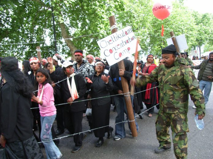 Tamils marching in London enact the horrors facing those interned in the Chettikulam concentration camp by the Sri Lankan army