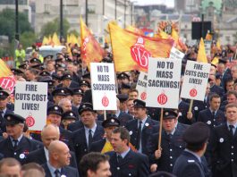 A section of the firefighters march in London on September 16 to defend jobs and demanding no cuts to the service