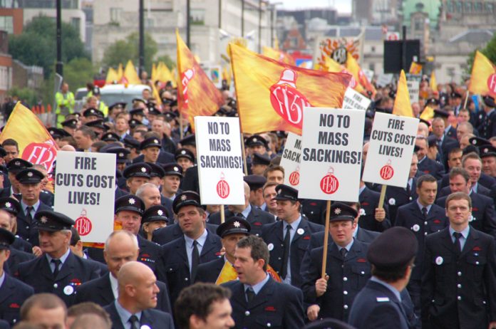 A section of the firefighters march in London on September 16 to defend jobs and demanding no cuts to the service