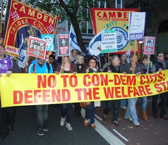 Workers marching on 10 Downing Street to condemn the savage cuts policy of Cameron, Osborne and Clegg