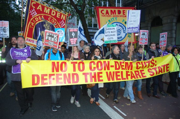 Workers marching on 10 Downing Street to condemn the savage cuts policy of Cameron, Osborne and Clegg