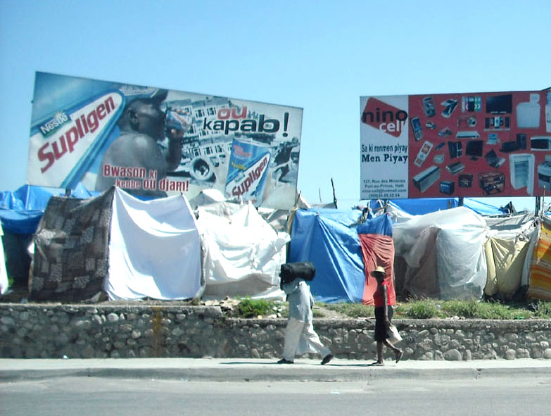 Haitians living in tents by the side of a main road