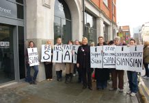 SIAN GRIFFITHS (centre) wearing her Queen’s Fire Service Medal, with supporters outside the London Fire Brigade HQ yesterday