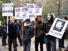 EXPOSING WAR CRIMES IS NO CRIME – Free Julian Assange! Young demonstrators showing their support for the WikilLeaks founder