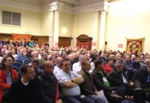 Over 1,000 postal workers rallied at the Central Hall in Westminster yesterday mid-day to fight the plan to privatise Royal Mail which threatens 30,000 jobs