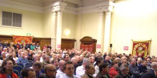 Over 1,000 postal workers rallied at the Central Hall in Westminster yesterday mid-day to fight the plan to privatise Royal Mail which threatens 30,000 jobs