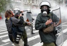 Riot police attack MARIOS LOLOS the President of the Greek Union of Press Photographers (EEF) outside the Vouli (Greek parliament) on 15 December.(Photo courtesy of EEF)