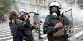 Riot police attack MARIOS LOLOS the President of the Greek Union of Press Photographers (EEF) outside the Vouli (Greek parliament) on 15 December.(Photo courtesy of EEF)