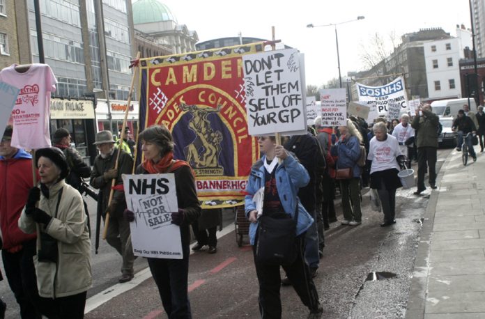Camden GPs marching against NHS privatisation. Meanwhile the Tory-led coalition says that under-5s don’t need anti-flu jabs