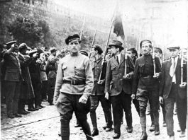 TROTSKY (far left) reviews a Red Square march of workers and soldiers. They were clear that their revolution was the start of the struggle to smash capitalism and imperialism worldwide