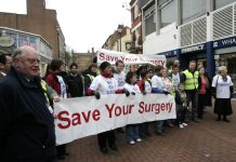 GPs and local residents join hands to stop the closure of GP surgeries in a demonstration in Rugby