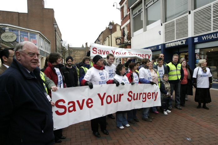 GPs and local residents join hands to stop the closure of GP surgeries in a demonstration in Rugby