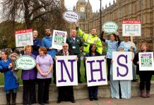 Health workers show their opposition to the privatisation outside parliament yesterday