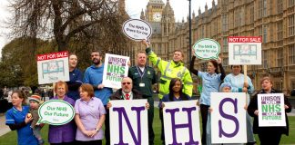Health workers show their opposition to the privatisation outside parliament yesterday