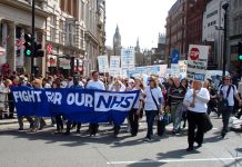 Health workers march through the centre of London to defend the National Health Service