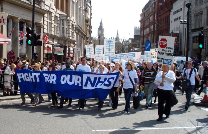Health workers march through the centre of London to defend the National Health Service