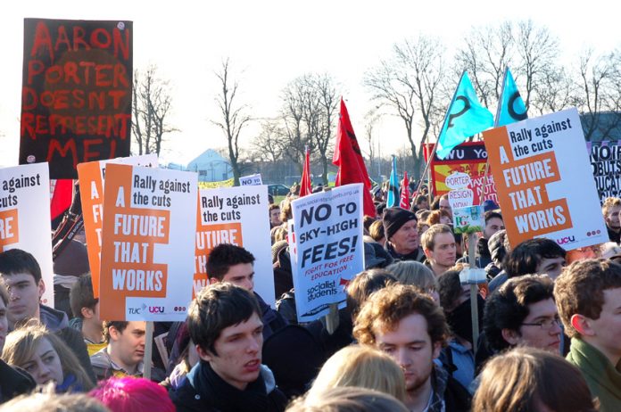 Students and workers rally in Manchester against tuition fees and cuts – a placard reads: ‘’Aaron Porter doesn’t represent me’