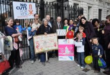 Sure Start Children’s Centre campaigners and children outside Downing Street with the over 50,000-strong petition opposing the centres closures