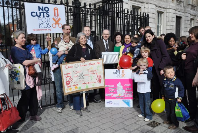 Sure Start Children’s Centre campaigners and children outside Downing Street with the over 50,000-strong petition opposing the centres closures