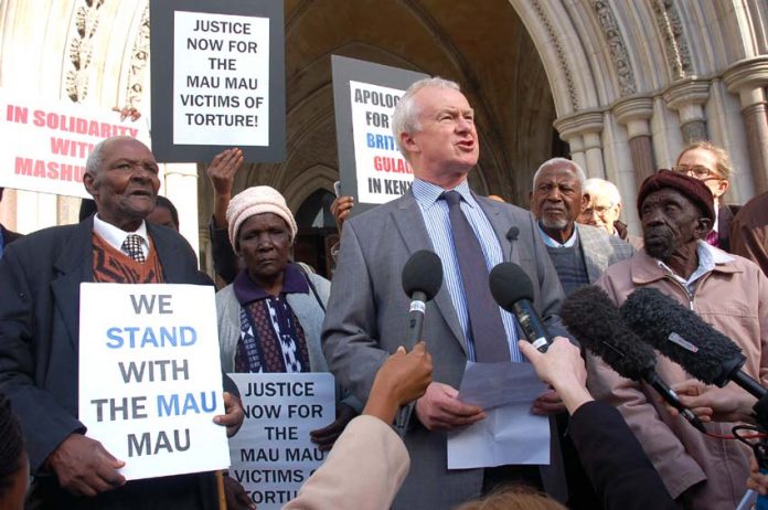 The four Kenyan claimants with lawyer Martin Day outside the High Court before the start of yesterday’s hearing