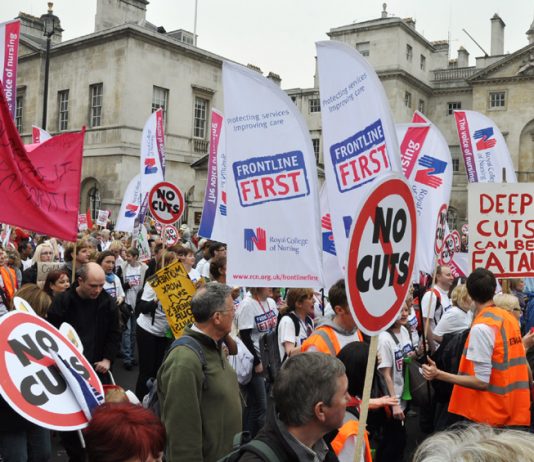 Members of the Royal College of Nursing with their banners demonstrating against mass sackings of NHS staff on March 26