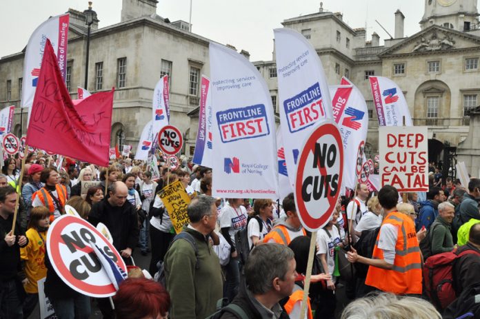 Members of the Royal College of Nursing with their banners demonstrating against mass sackings of NHS staff on March 26