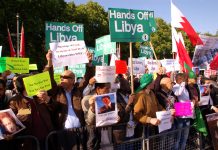 Libyan workers and youth gather outside Buckingham Palace to demand of the Queen and Obama that their forces quit Libya