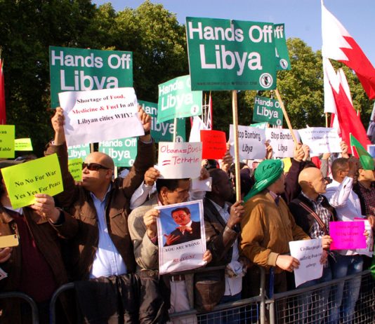 Libyan workers and youth gather outside Buckingham Palace to demand of the Queen and Obama that their forces quit Libya