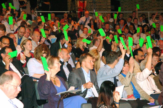 Doctors voting at yesterday’s GPs conference where they rejected the government’s NHS privatisation plans